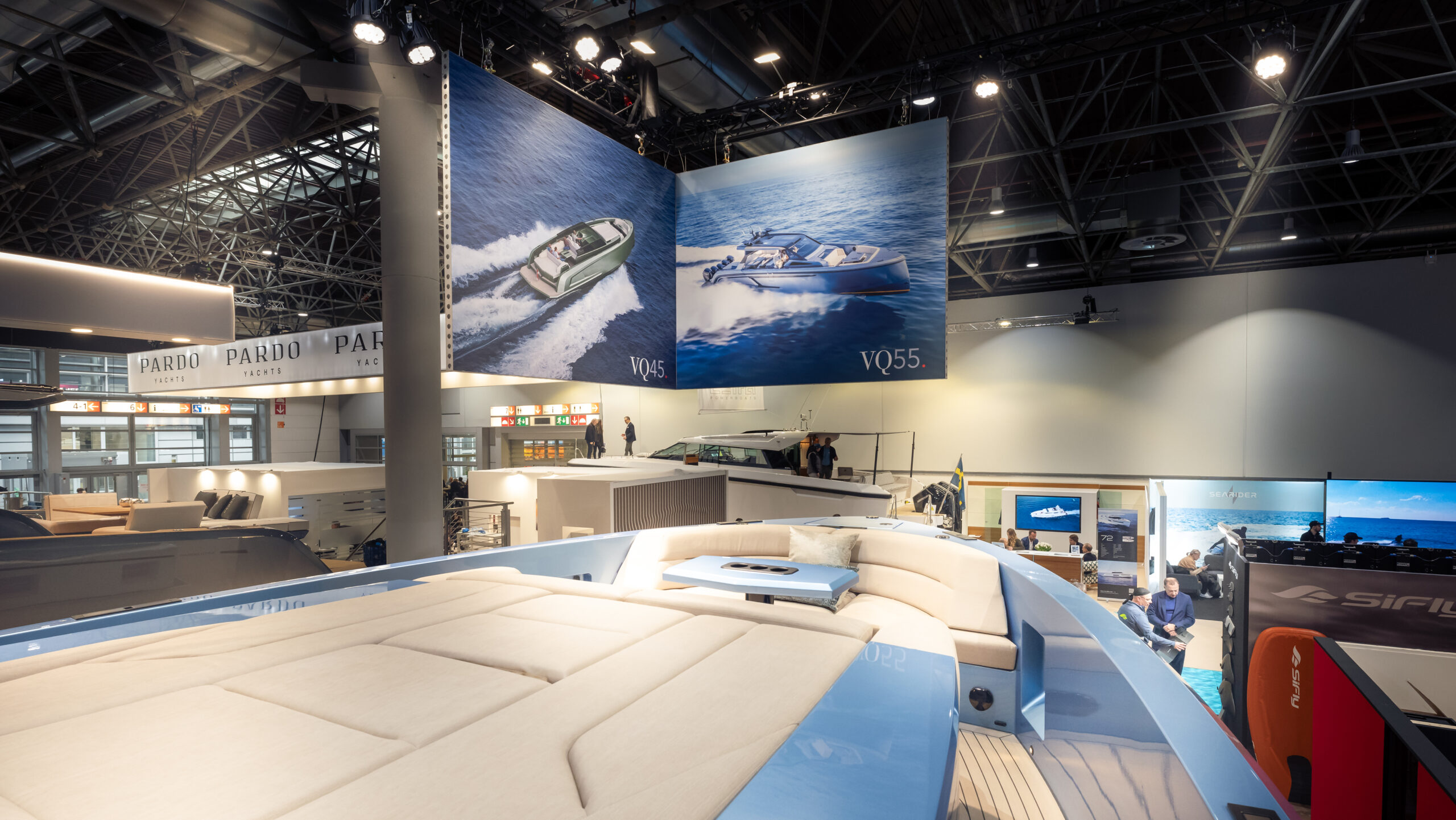 A Vanquish Yachts stand at a boat show with branded signing