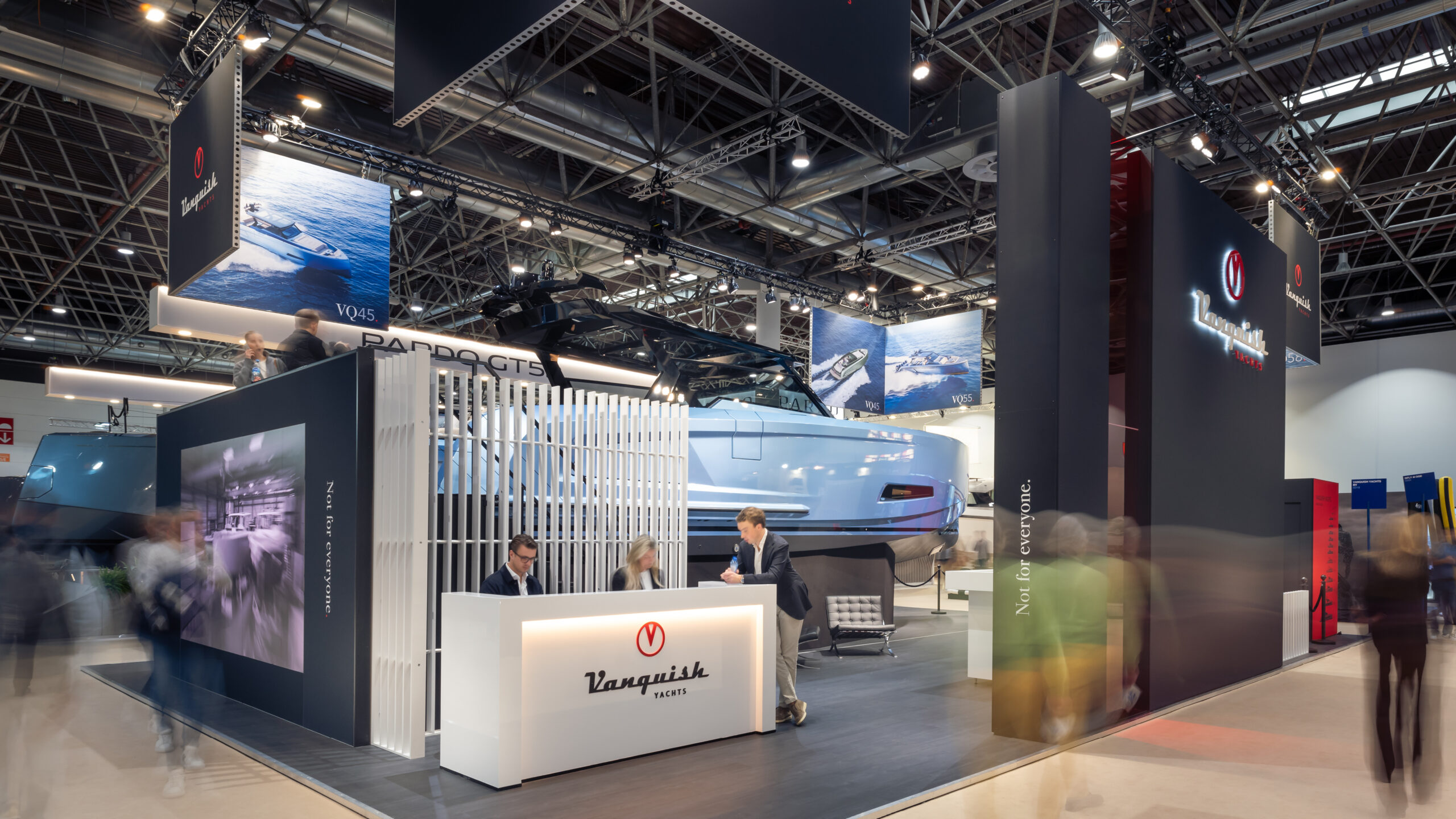 A Vanquish Yachts stand at a boat show with branded signing