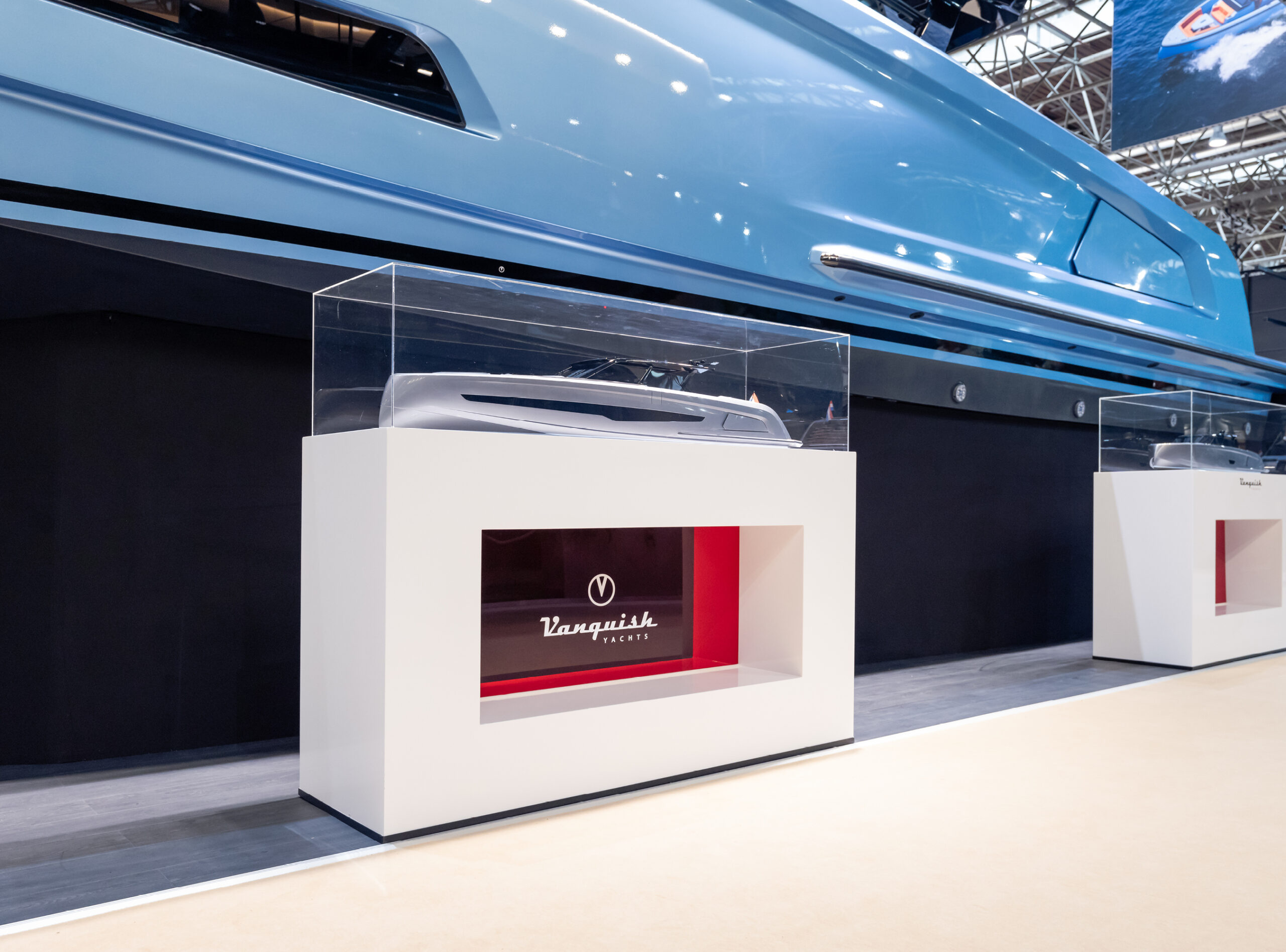 A Vanquish Yachts stand at a boat show with branded signing