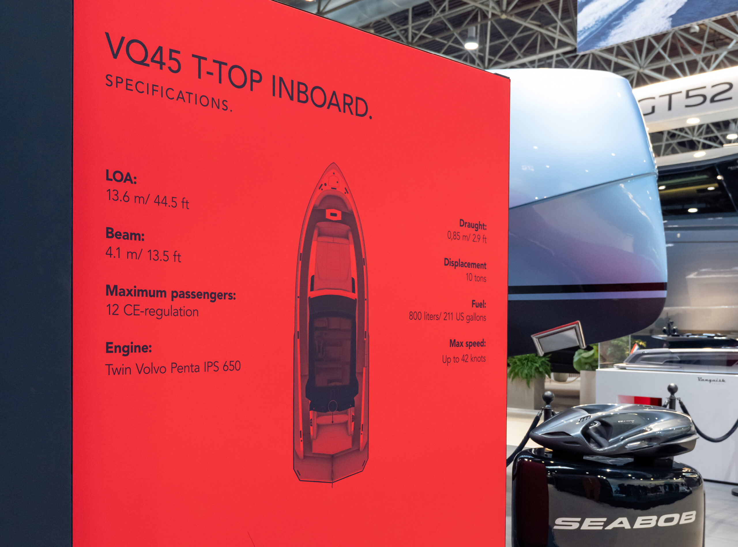 A Vanquish Yachts stand at a boat show with branded signing