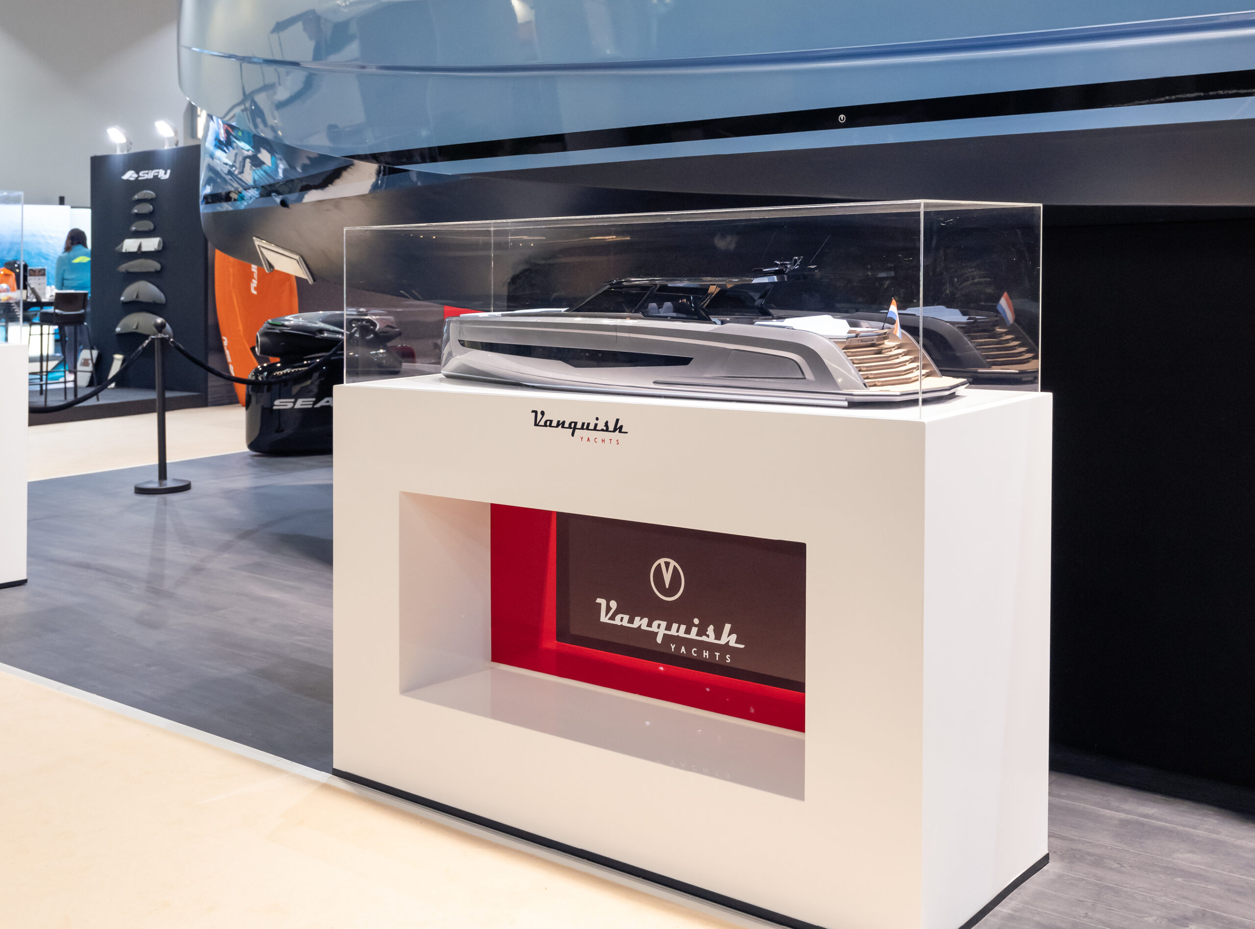 A Vanquish Yachts stand at a boat show with branded signing