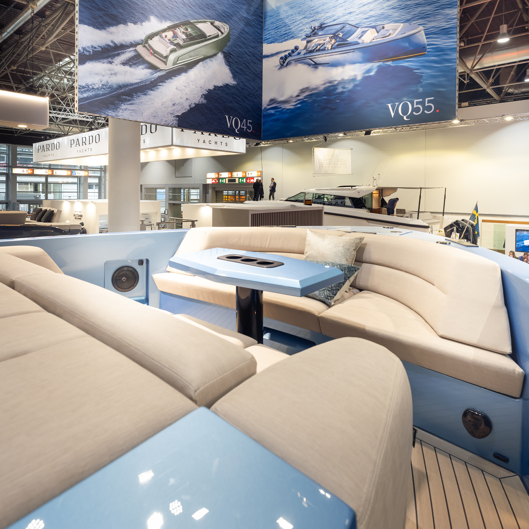 A Vanquish Yachts stand at a boat show with branded signing