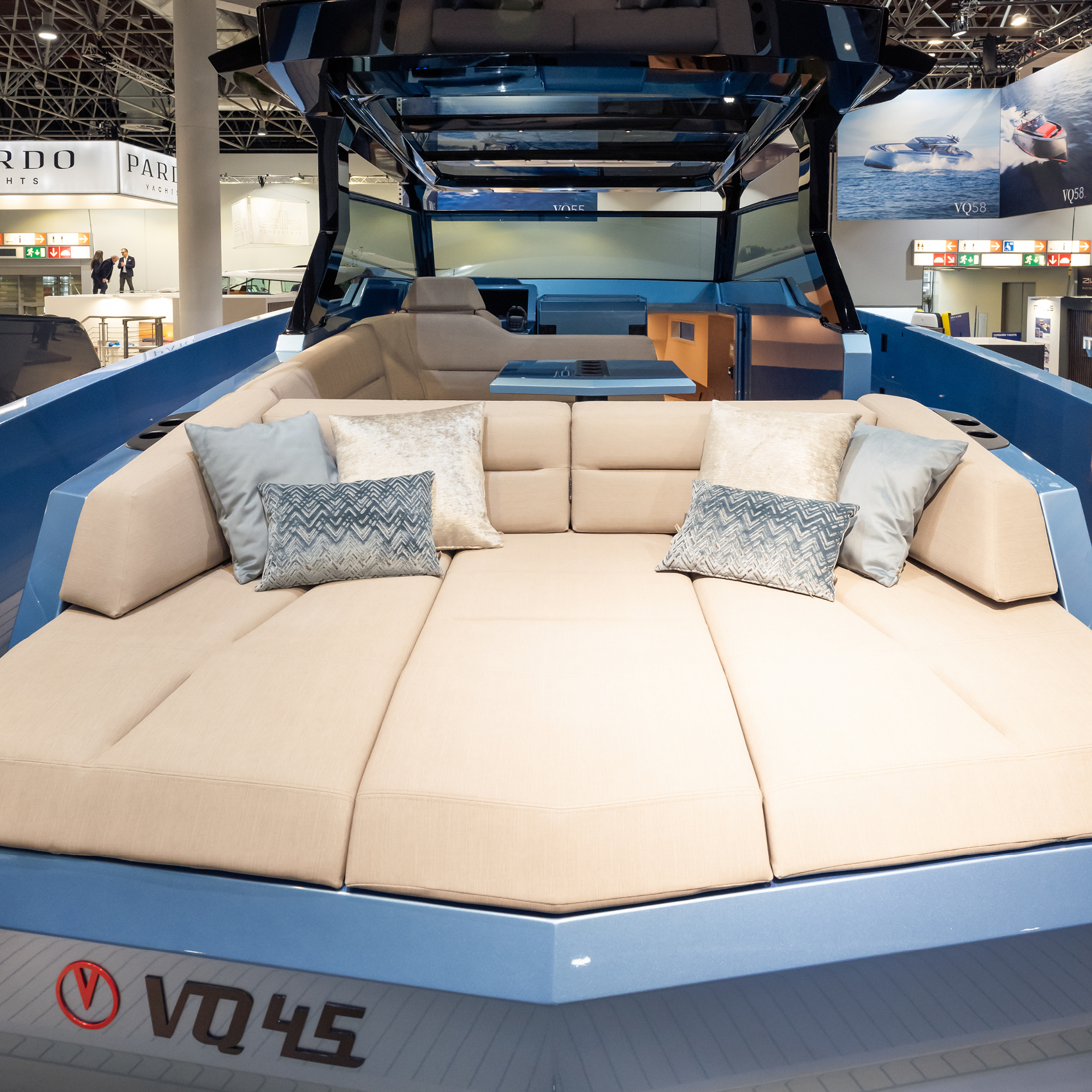 A Vanquish Yachts stand at a boat show with branded signing